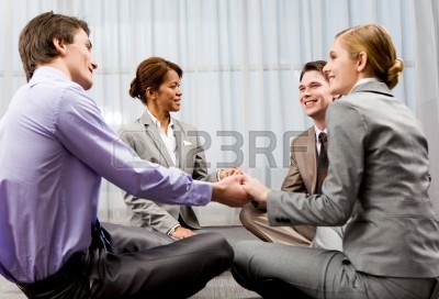 8447427-portrait-of-happy-business-people-holding-each-other-by-hands-and-communicating-while-sitting-on-the.jpg