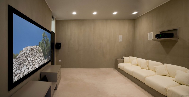long-sofa-earthy-wall-color-earthy-floor-giant-TV.jpg