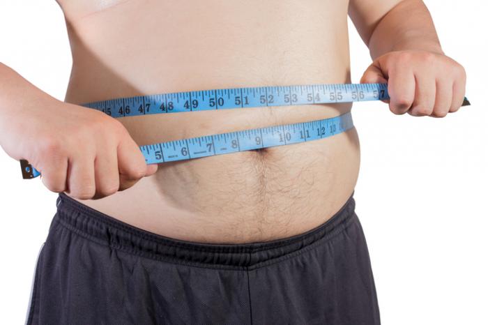 an-overweight-man-measuring-his-waist.jpg