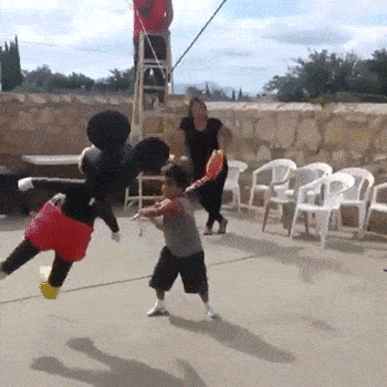 kid-attacking-pinata-mickey-mouse-punching-14098502448.gif