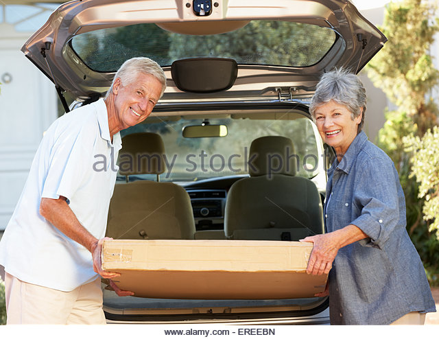 senior-couple-loading-large-package-into-back-of-car-ereebn.jpg