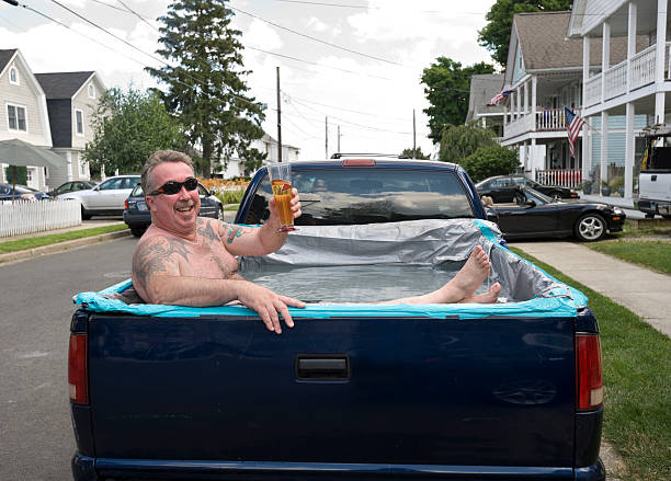 redneck-swimming-pool-man-relaxing-in-pickup-truck-picture-id173945034