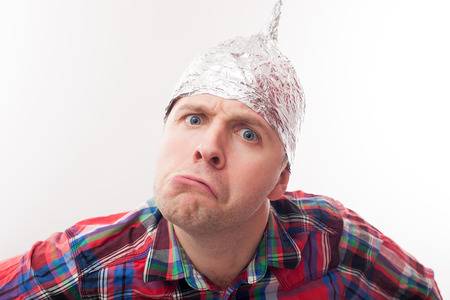 71180264-young-man-in-a-tin-foil-hat-displeased-looks-forward-afraid-of-radiation-or-aliens.jpg