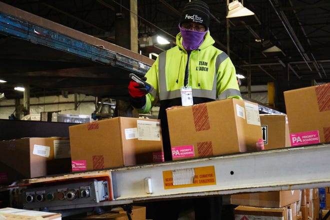 A FedEx Express employee moves the distribution process along for doses of the Johnson & Johnson COVID-19 vaccine at the FedEx Express World Hub in Memphis, Tennessee on March 1, 2021.