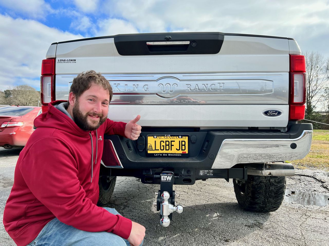 Nathan Kirk in front of his license plate